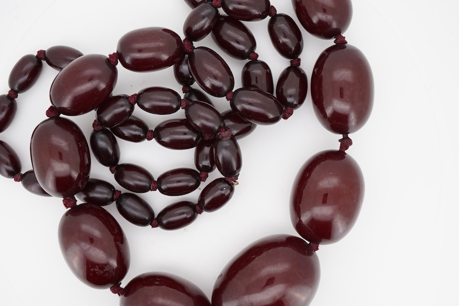 A single strand simulated cherry amber bead necklace, with graduated oval beads, 72cm, gross weight 73 grams.